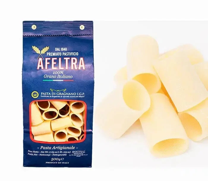 Afetra premium artisanal Italian paccheri pasta in blue packaging and loose pasta pieces