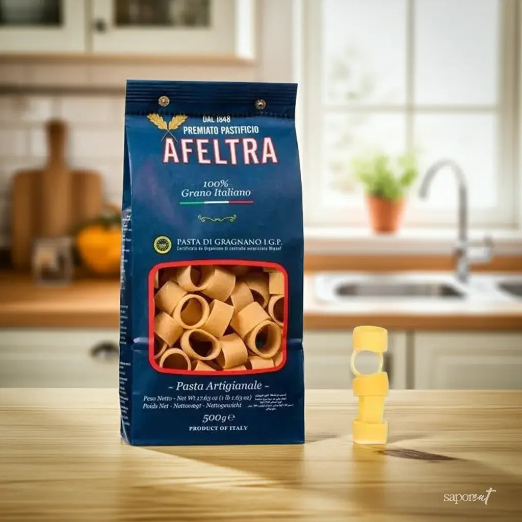 Afeltra 500g pasta di Gragnano rigatoni pasta package on kitchen table with stacked pasta rings