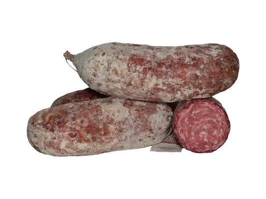 Three pieces of rustic cured Finocchiona salami, one sliced to show marbled interior