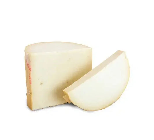 Block and wedge of firm provolone cheese with natural rind on white background