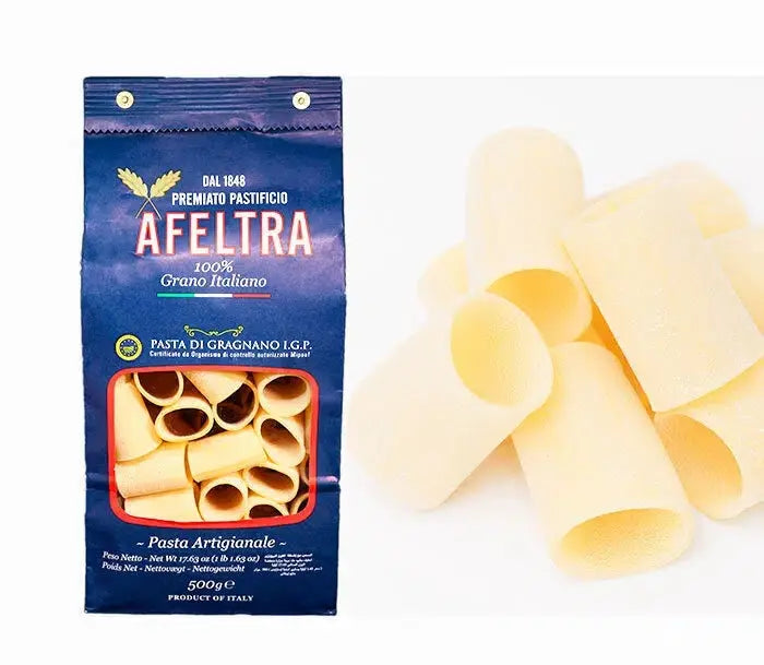 Afetra premium artisanal Italian paccheri pasta in blue packaging and loose pasta pieces