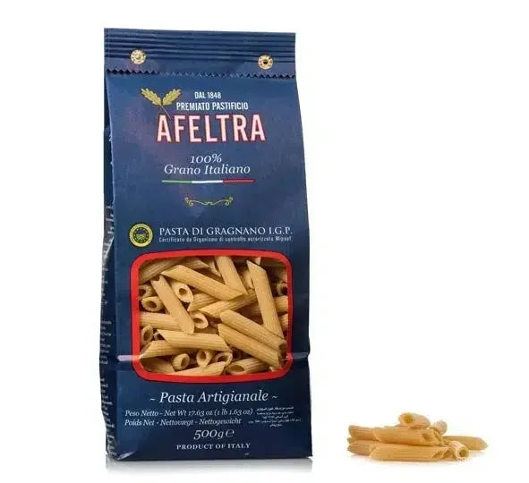 Blue bag of Afeltra Penne Rigate Italian pasta with some pasta pieces beside it