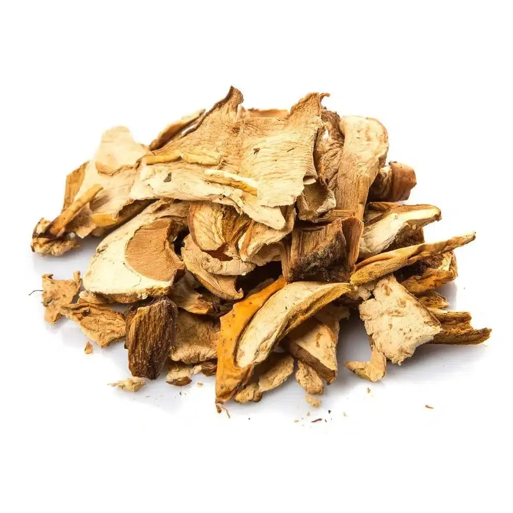 Pile of premium dried porcini mushroom slices on white background