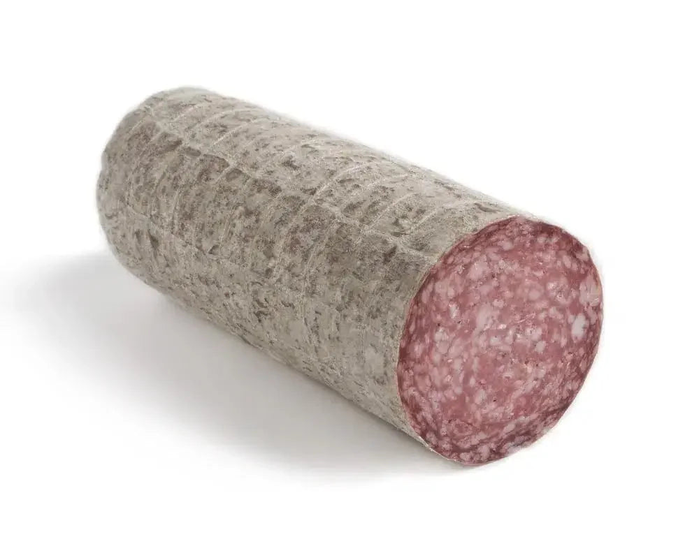 Whole cured salami with gray rind and visible marbled pink meat on white background